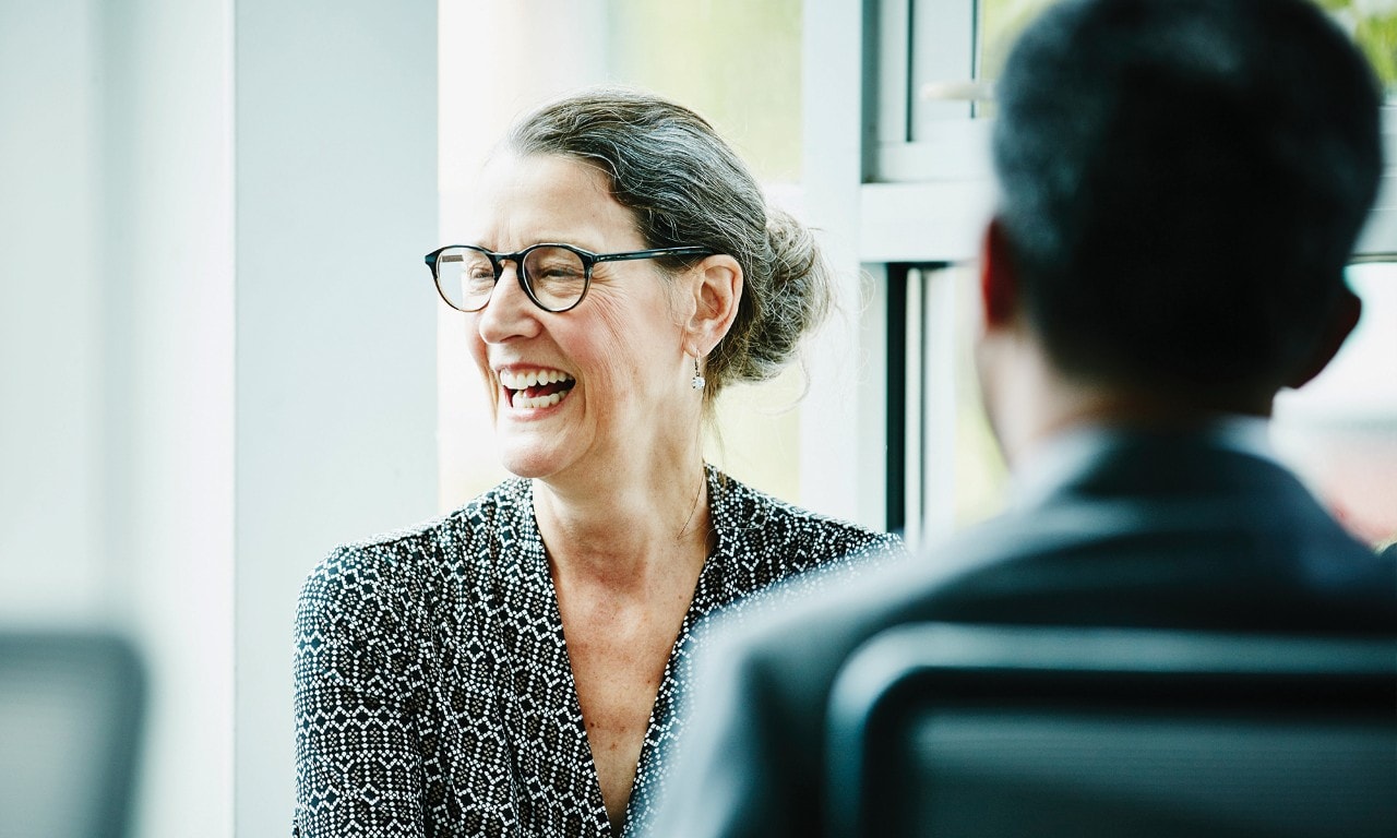 Woman laughing in a meeting